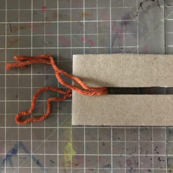 Thread Tying Thread thru Slot on Loom