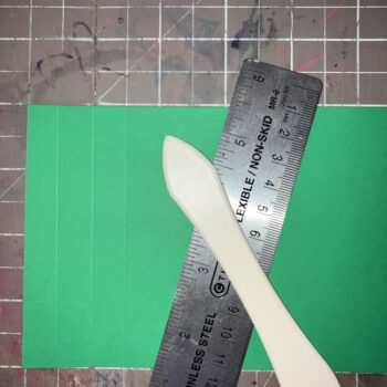 Score Green Cardstock at Half Inch Intervals