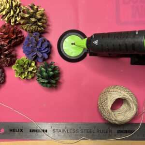Hot Glue Twine to Top of Pinecones to Finish Garland