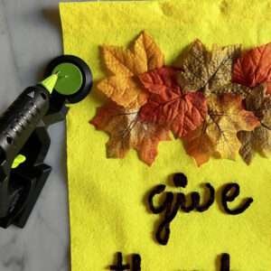 Hot Glue Individual Leaves in Place on Thanksgiving Door Banner