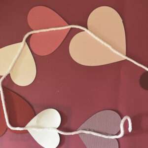 Continue Gluing Hearts on Yarn to Form a Streamer