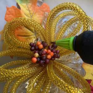 Hot Glue Artificial Berries to Center of Mesh Tubing Bow